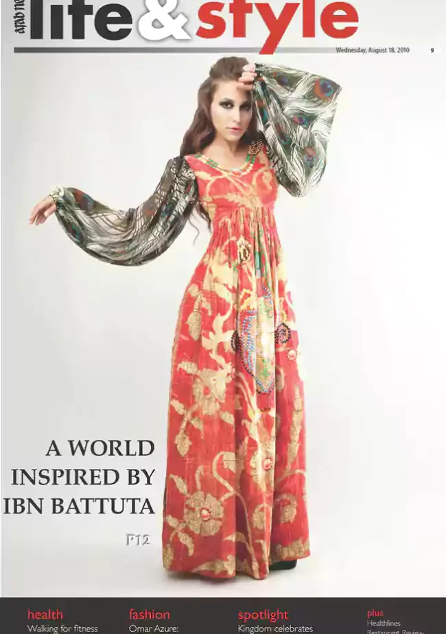 Model wears a red and gold Shrekahnth kaftan with peacock-feather print sleeves on the Arab News Life & Style cover, themed “A World Inspired by Ibn Battuta.”